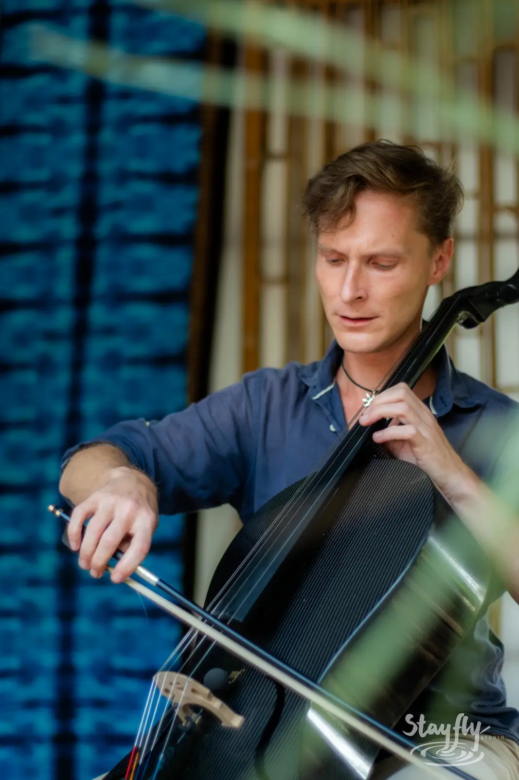 Cellist performing on stage.