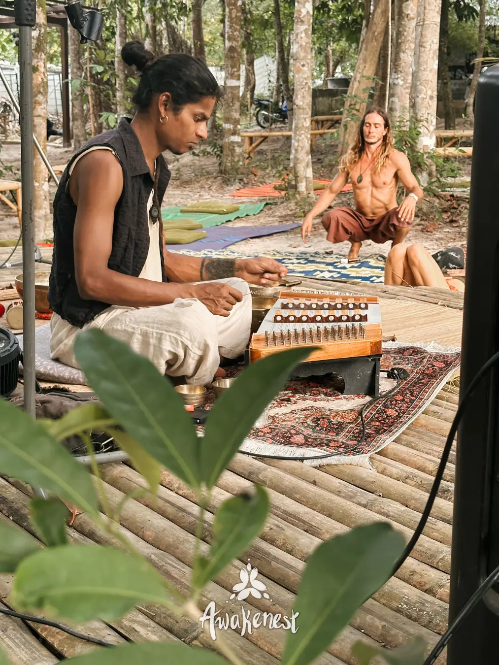 Two musicians playing instruments outdoors.