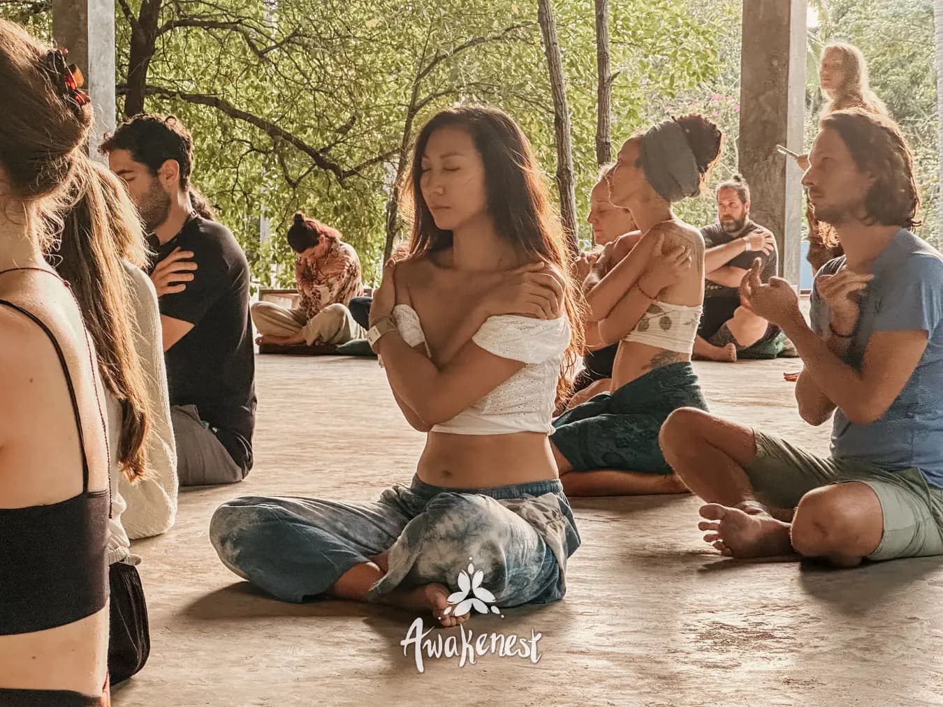 Breathwork circle with arms crossed at chest.