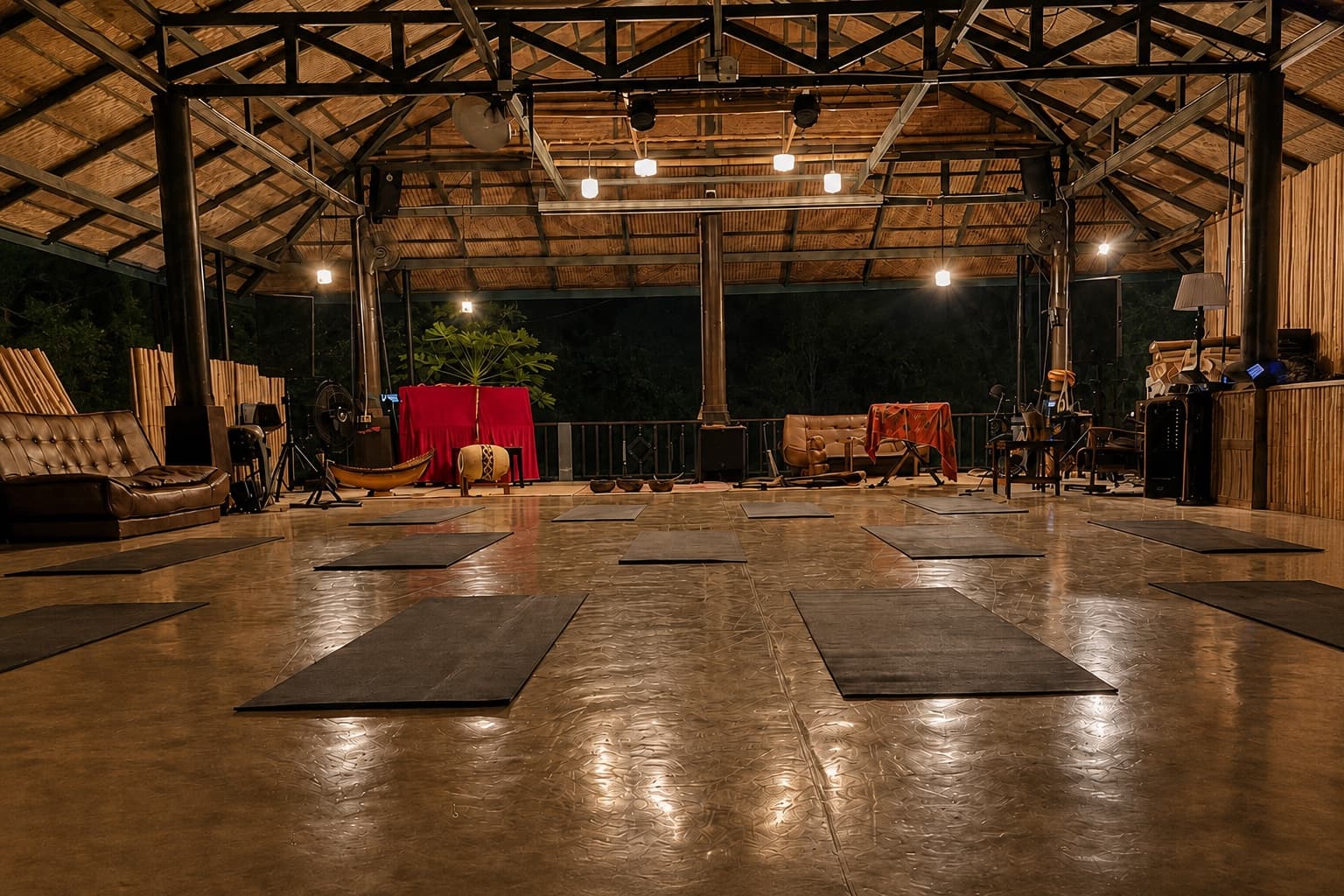 Mats arranged inside the open-air wooden shala at Stayfly.